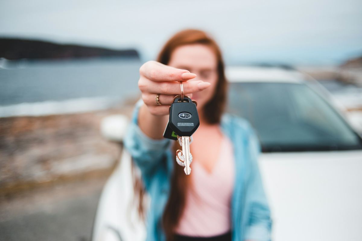 A new owner holding up the car key