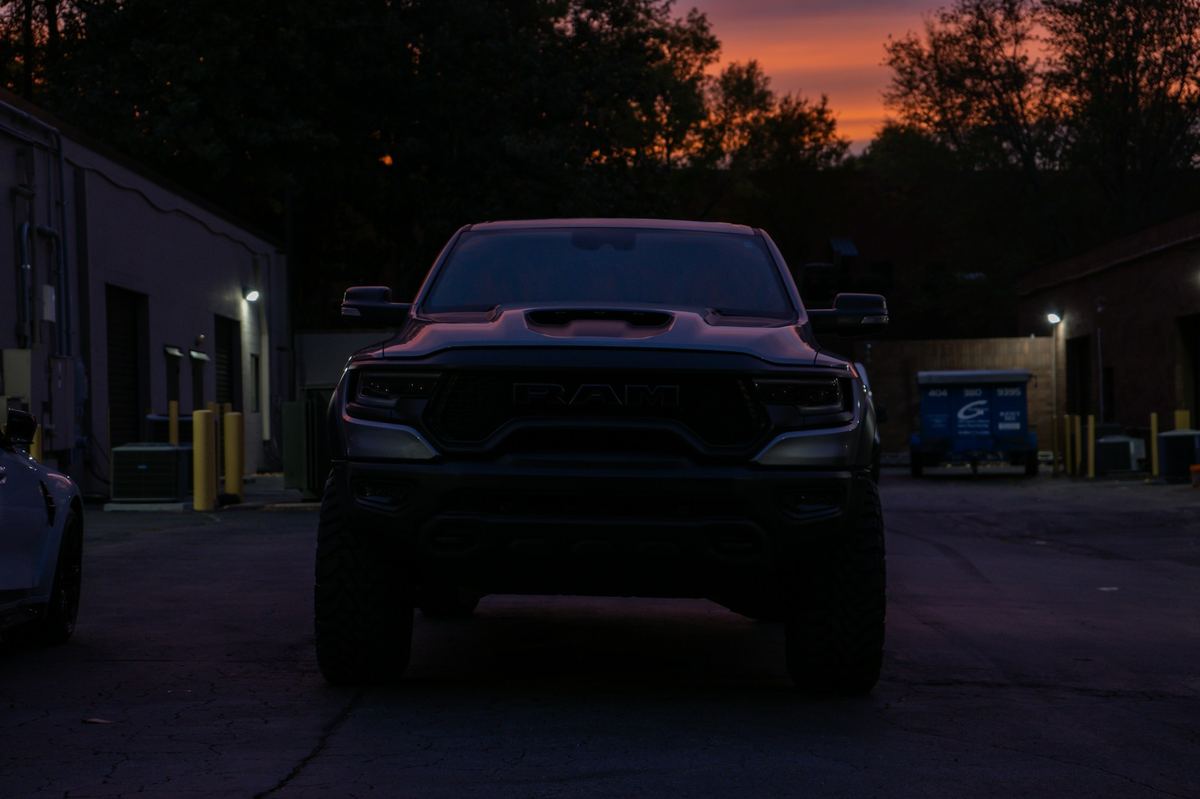 A dark full-size pickup truck parked at dusk
